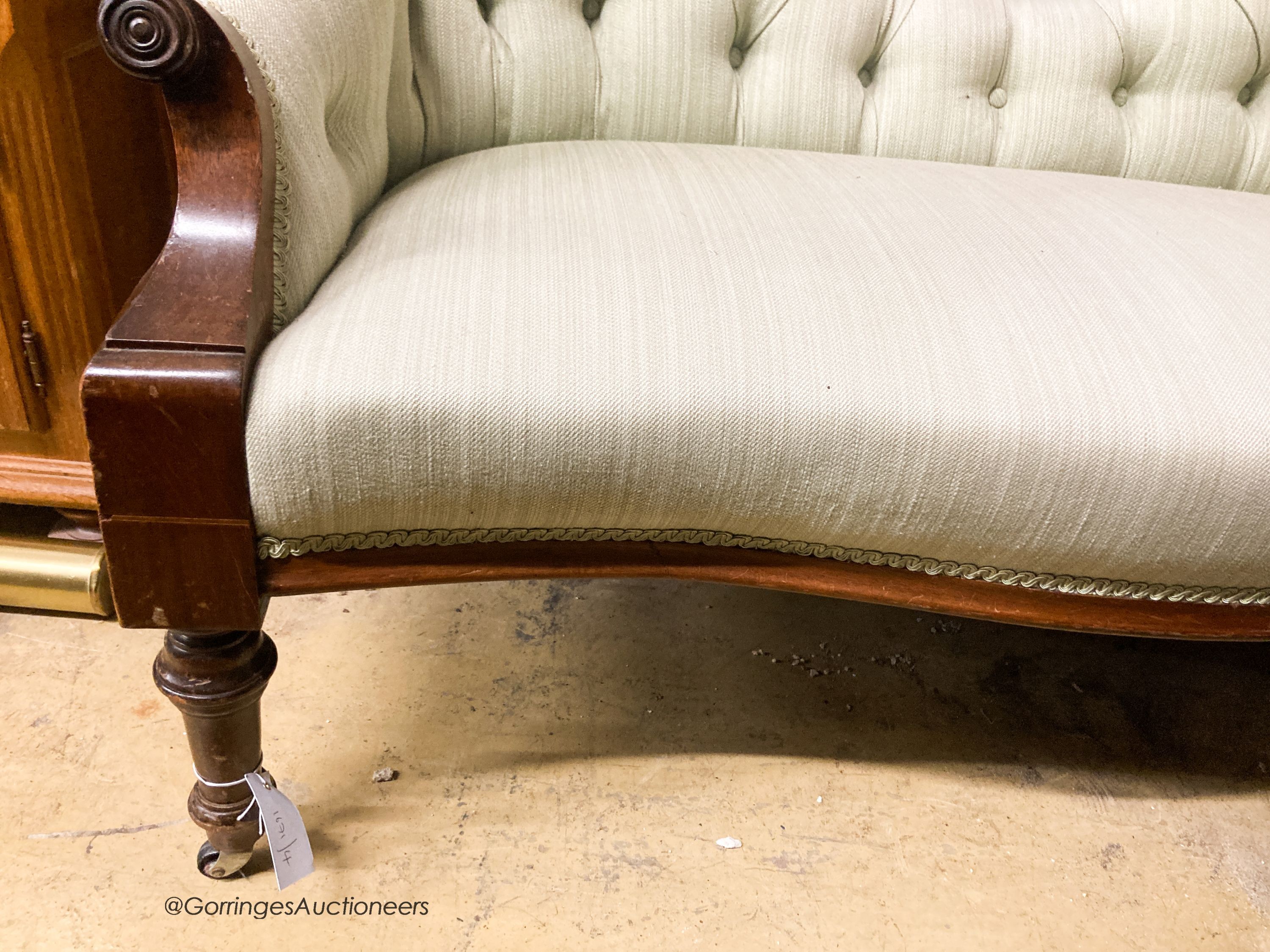 A Victorian mahogany double spoon back settee upholstered in buttoned green fabric, width 130cm, depth 58cm, height 76cm